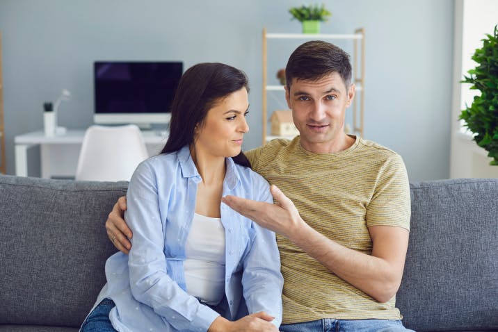 Couple sitting next to each other on couch